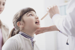 physician-checking-girls-throat