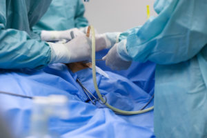 Operating room with patient on table surrounded by medical professionals