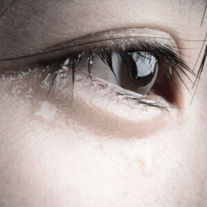 Woman with tears in her eye.