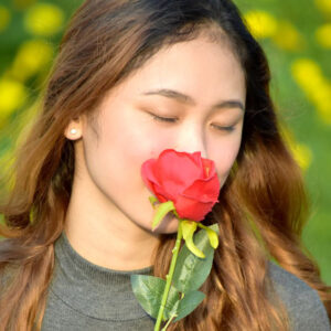 Woman smelling a rose.